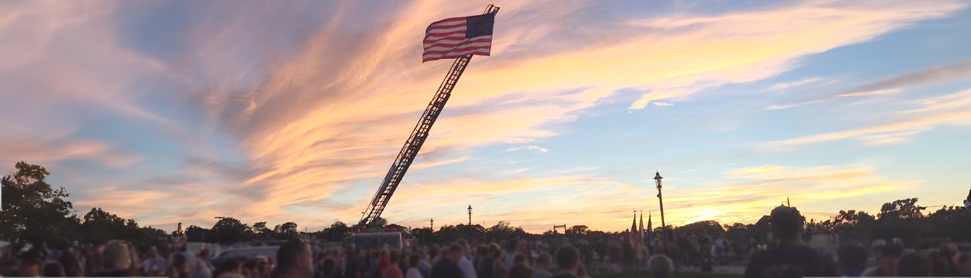 American flag waving on firetruck lader